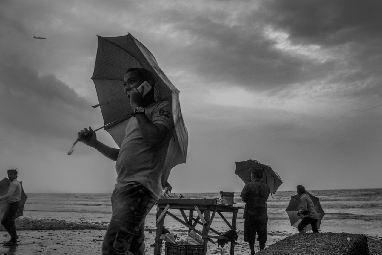 The skies swell up and strong winds bellow fiercely; the atmosphere laden with the scent of monsoon and the collective anticipation of a downpour both unforgiving and spectacular.
Taken at Juhu beach.
Bombay / Mumbai, India.